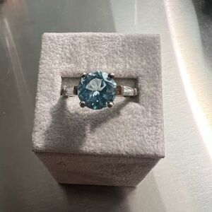 Large Blue Topaz and Sterling Silver Ring with Baguette CZ on Sides.